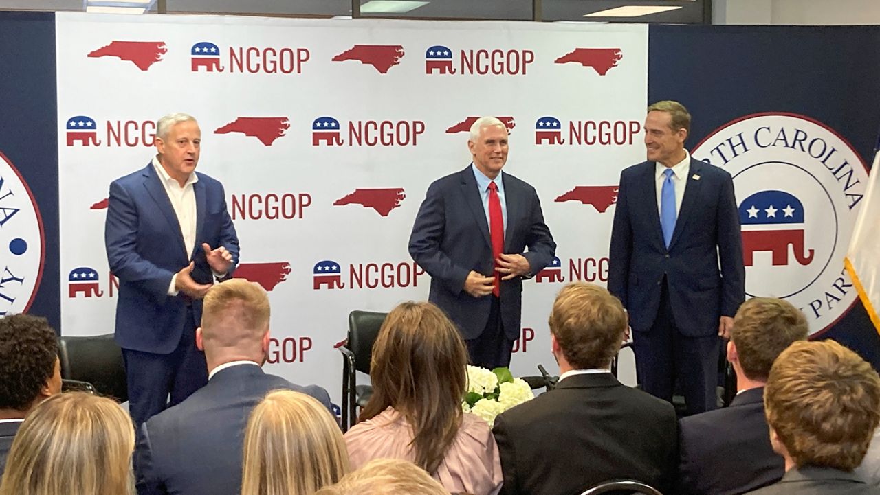 Former Vice President Mike Pence, center, joins N.C. Republican Party Chairman Michael Whatley, left, and U.S. Senate candidate Ted Budd at the state GOP headquarters in Raleigh, N.C., on Wednesday. Nov. 2, 2022. Pence was in North Carolina to support Budd’s campaign. (AP Photo/Gary D. Robertson)