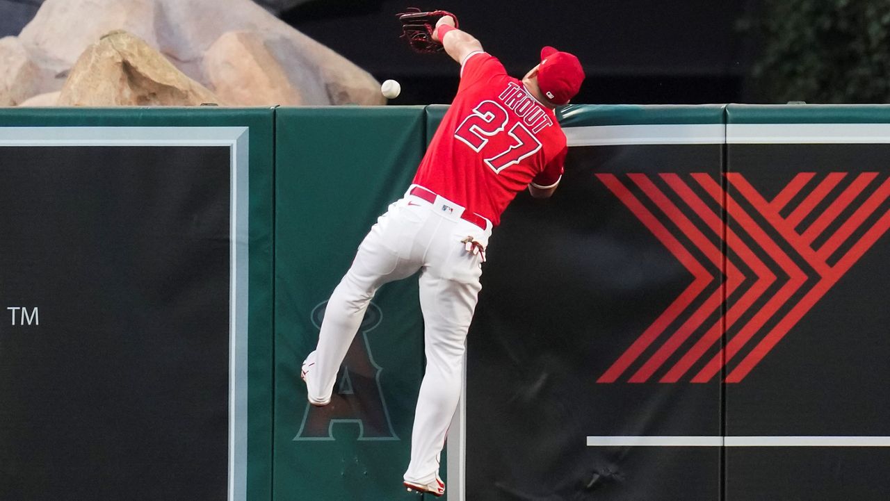 Los Angeles Angels center fielder Mike Trout (27) can’t catch a home run hit by Oakland Athletics’ Jesus Aguilar during the third inning of a baseball game Monday in Anaheim, Calif. (AP Photo/Ashley Landis)