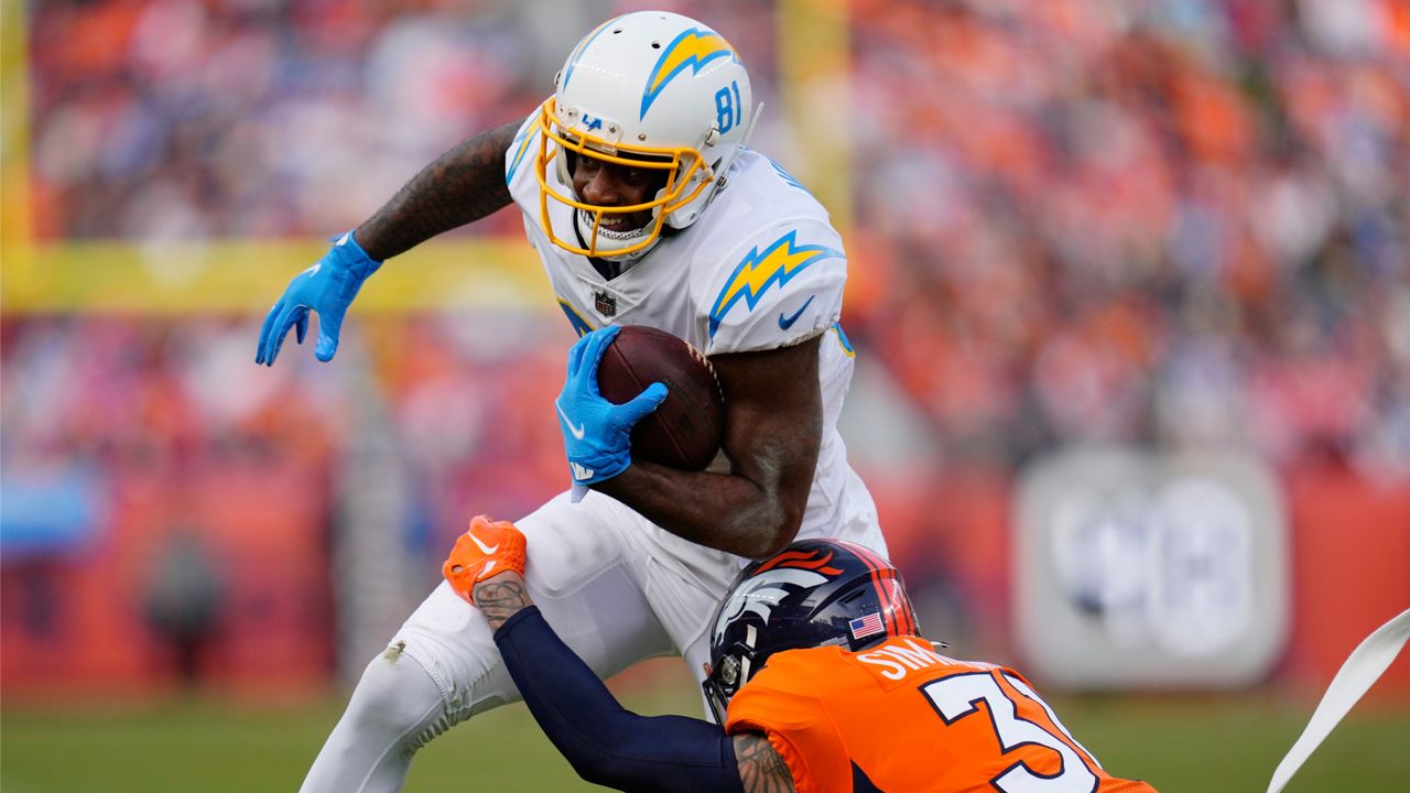 Los Angeles Chargers wide receiver Mike Williams (81) is hit by Denver Broncos safety Justin Simmons (31) after making a catch during the first half of an NFL football game in Denver, Sunday, Jan. 8, 2023. (AP Photo/Jack Dempsey)