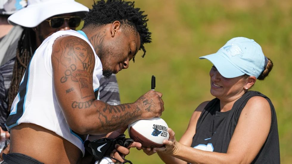 Carolina Panthers running back Miles Sanders signs autographs at the NFL football team's training camp on Thursday, July 27, 2023, in Spartanburg, S.C. (AP Photo/Chris Carlson)