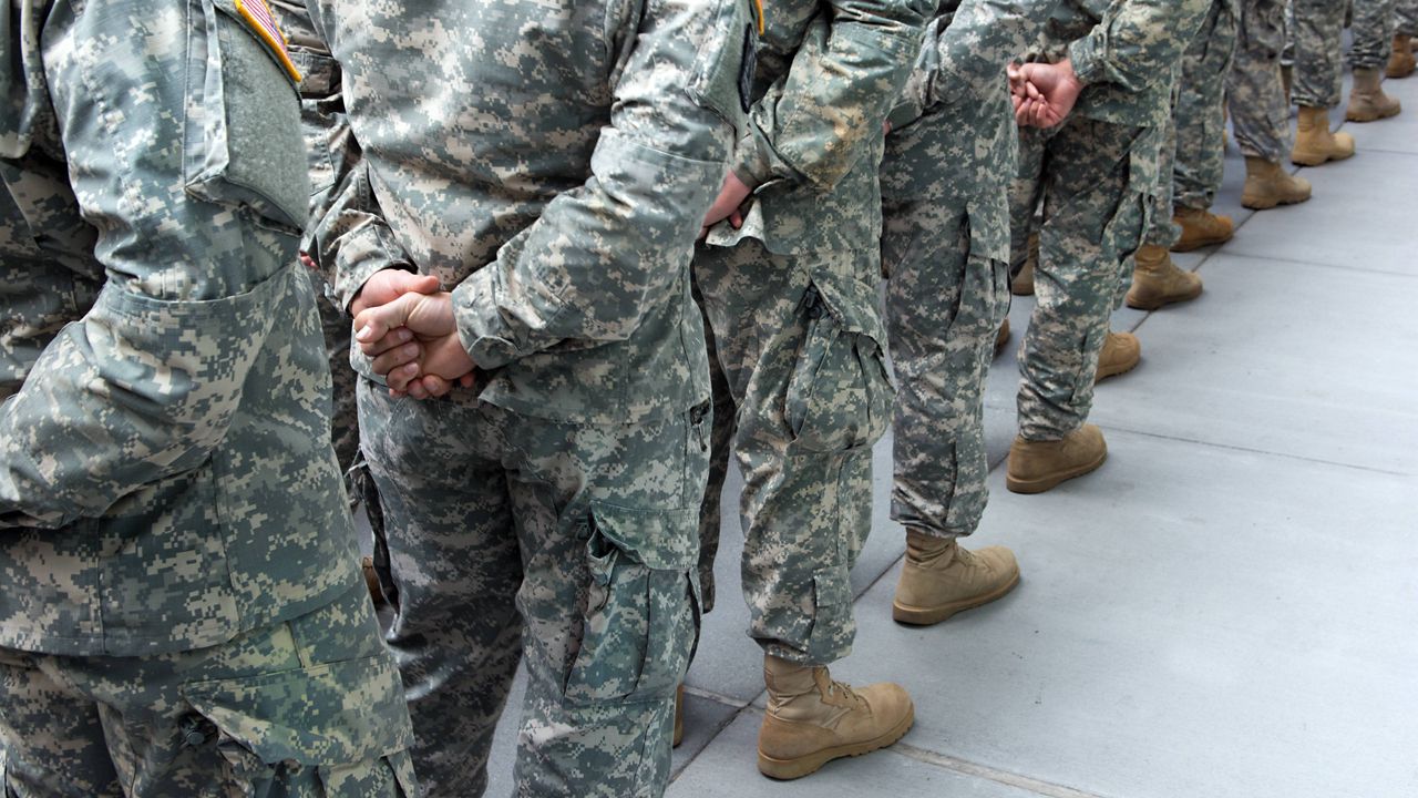 Military members lined up in a row (Courtesy/Getty)