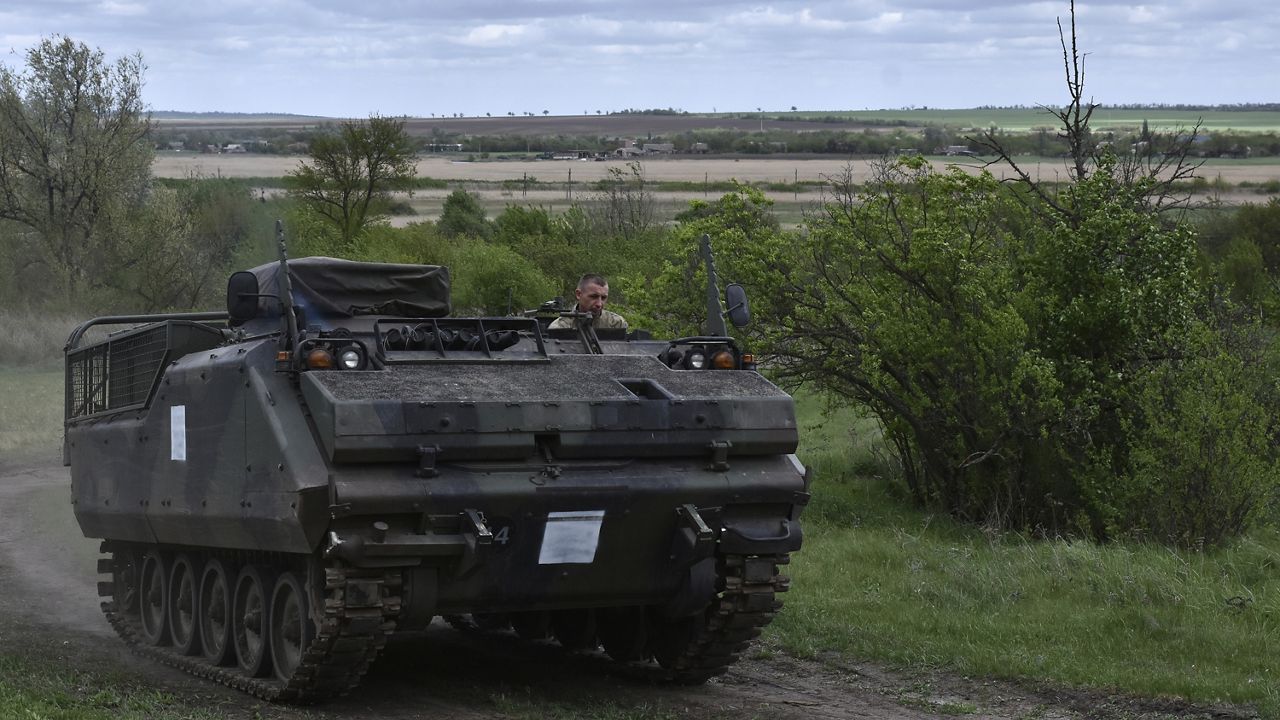 FILE - A Ukrainian serviceman with the 65th Brigade rides in an armored vehicle at the frontline in Zaporizhzhia region, Ukraine, Sunday, April 21, 2024. (AP Photo/Andriy Andriyenko)