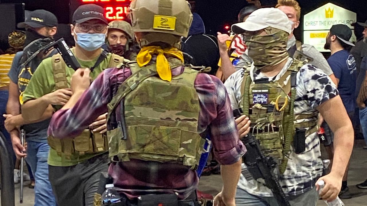 A group of armed young men at a gas station in downtown Kenosha Tuesday night, just minutes before a fatal shooting. (Photo by Sabra Ayres/Spectrum News)