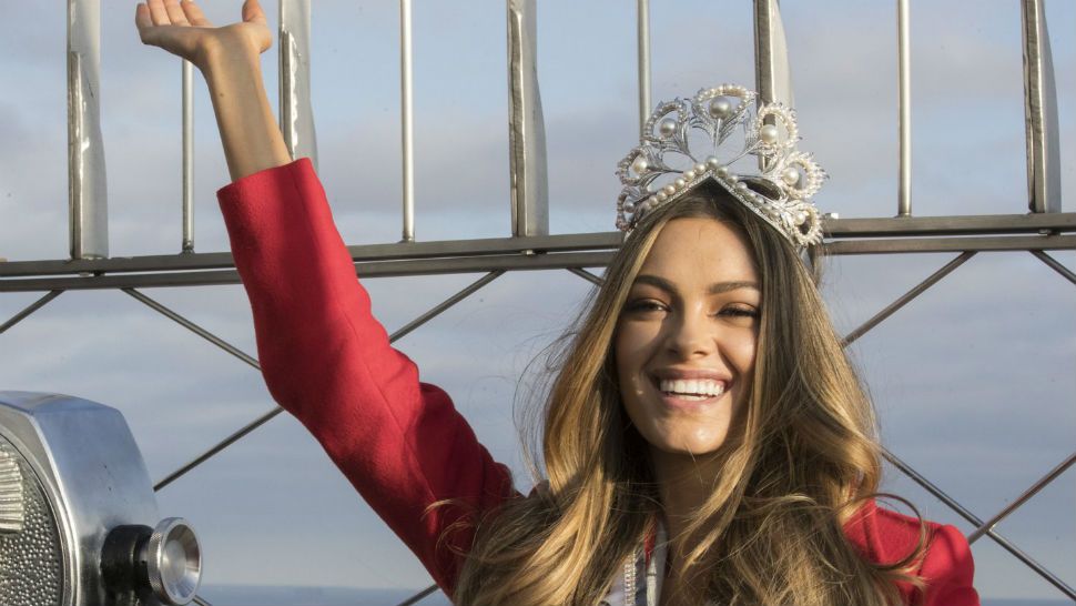 FILE - In this Tuesday, Nov. 28, 2017 file photo, Miss Universe 2017 Demi-Leigh Nel-Peters, of South Africa, poses for photographers on the 86th Floor Observation Deck of the Empire State Building in New York. Former Denver Broncos and University of Florida quarterback Tim Tebow is engaged. The Heisman Trophy winner announced his engagement on Instagram Thursday, Jan. 10, 2019 to Demi-Leigh Nel-Peters, a South Africa native and the 2017 Miss Universe. (AP Photo/Mary Altaffer, File)