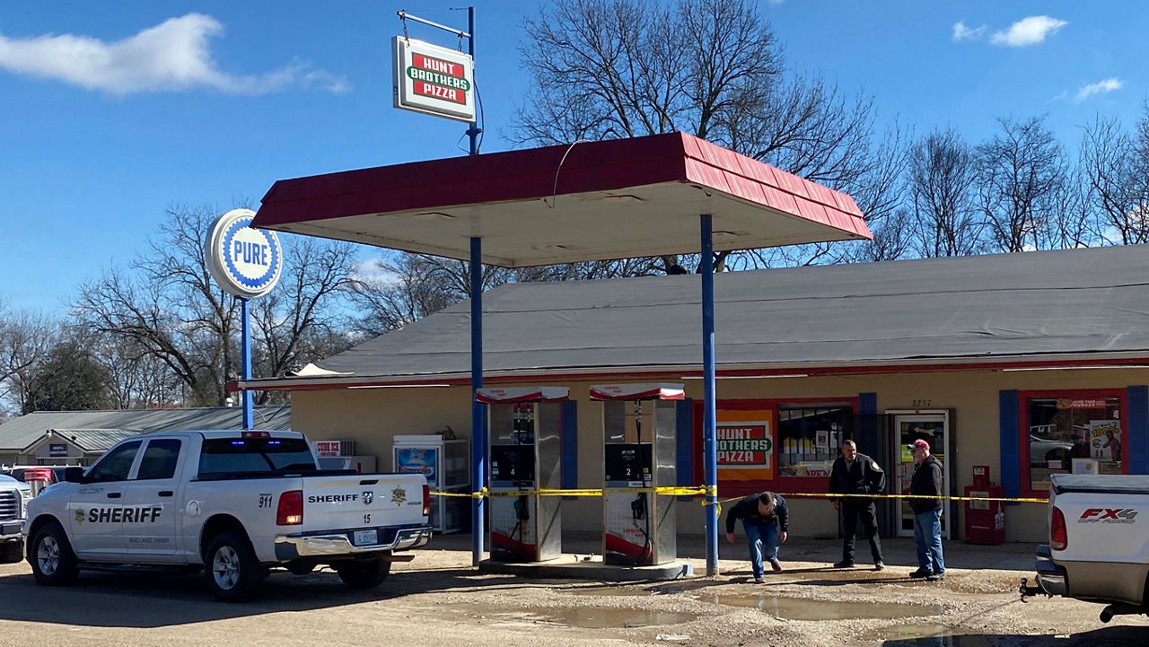 Law enforcement personnel work at the scene of a shooting, Friday, Feb. 17, 2023, in Arkabutla, Miss. Six people were fatally shot Friday in the small town in rural Mississippi near the Tennessee state line, and authorities said they had taken a suspect into custody. (Adam Itayem/NewsNation via AP)