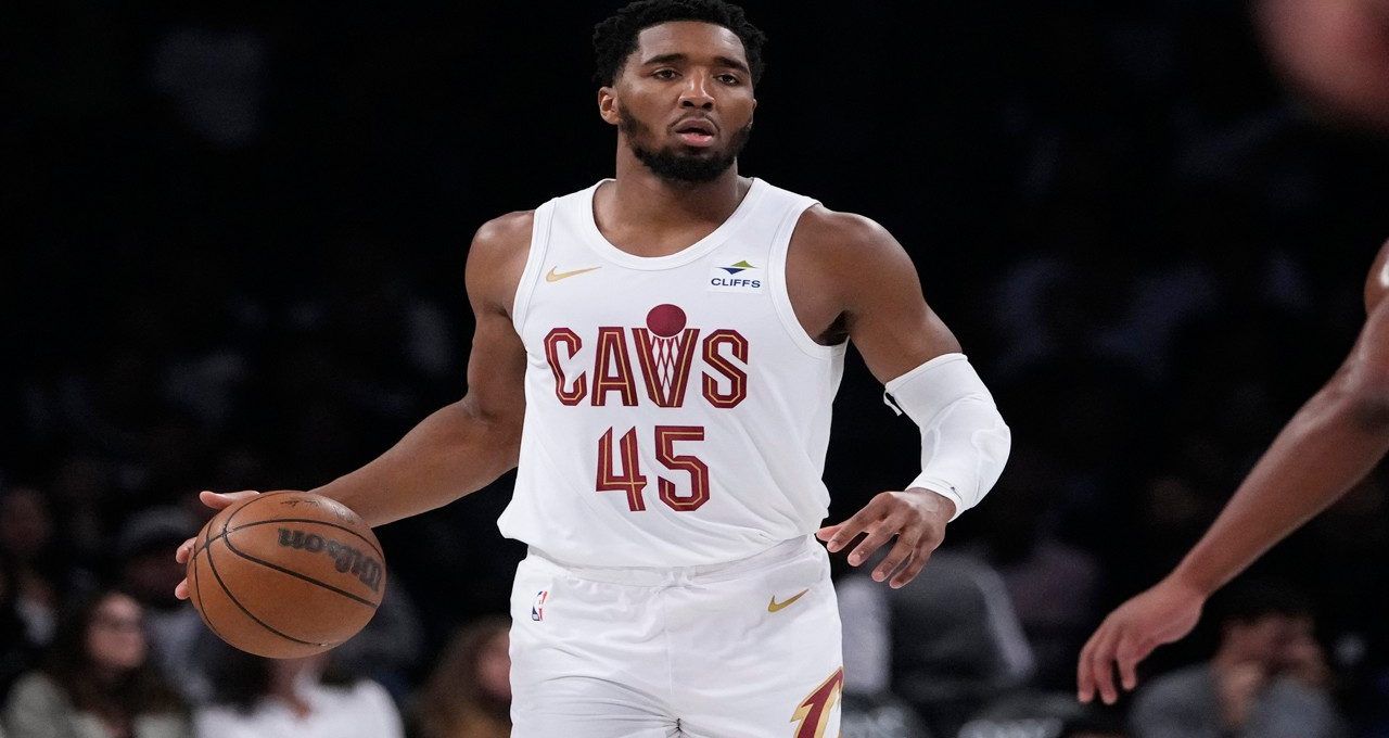 Cleveland Cavaliers guard Donovan Mitchell (45) shoots against Boston Celtics guard Malcolm Brogdon during the first half of an NBA basketball game, Monday, March 6, 2023, in Cleveland.