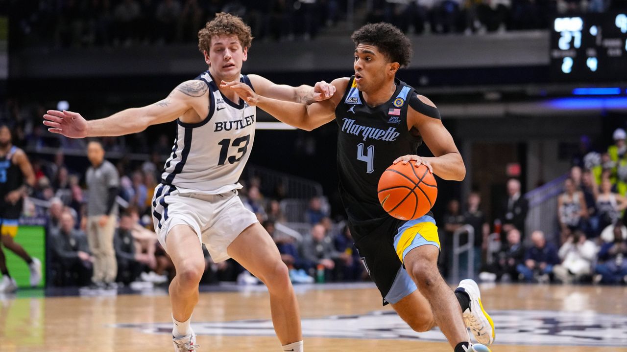 Marquette guard Stevie Mitchell (4) drives on Butler guard Finley Bizjack (13) in the first half of an NCAA college basketball game in Indianapolis, Tuesday, Jan. 28, 2025.