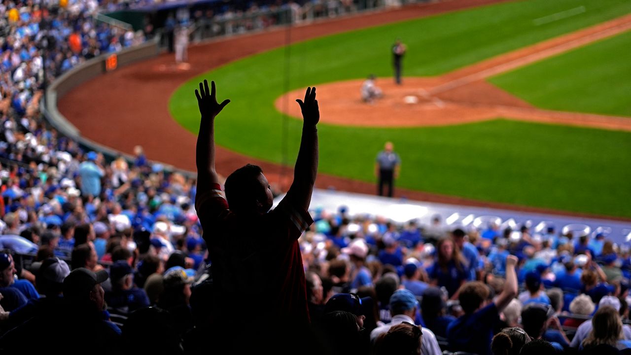 A fan cheers during the seventh inning of a baseball game between the Kansas City Royals and the San Francisco Giants Saturday, Sept. 21, 2024, in Kansas City, Mo. (AP Photo/Charlie Riedel)