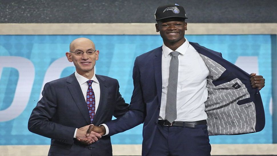 Texas’ Mohamed Bamba, right, poses with NBA Commissioner Adam Silver after he was picked sixth overall by the Orlando Magic during the NBA basketball draft in New York, Thursday, June 21, 2018. (AP Photo/Kevin Hagen)
