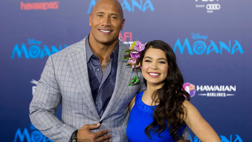 Actor Dwayne Johnson, left, and Auli'i Cravalho arrive at the 2016 AFI Fest - "Moana" World Premiere at El Capitan Theatre on Monday, Nov. 14, 2016, in Los Angeles. (Photo by AP/Willy Sanjuan/Invision)