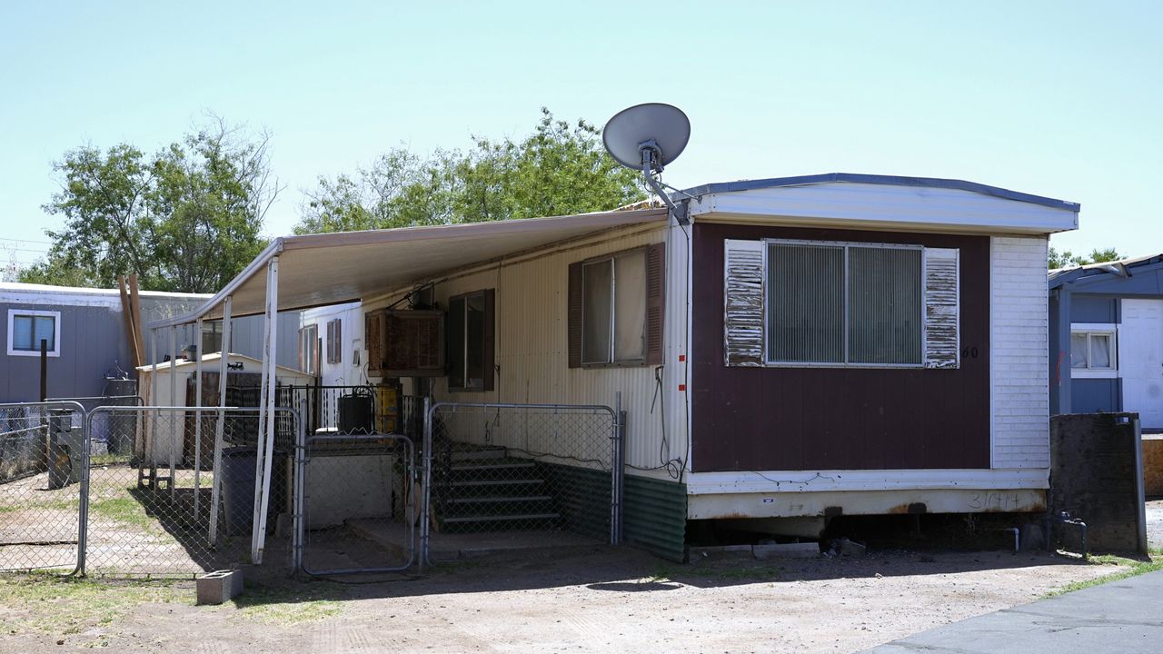 The mobile home where Shirley Kouplen lived shown Thursday, May 23, 2024, in Phoenix. Her mobile home cooling system stopped working during the sweltering heatwave of 2023, and by the time emergency responders arrived, the 70-year-old widow's temperature was 107.1 degrees, was diagnosed with heat stroke, suffered several heart attacks and later died at a local hospital. (AP Photo/Ross D. Franklin)