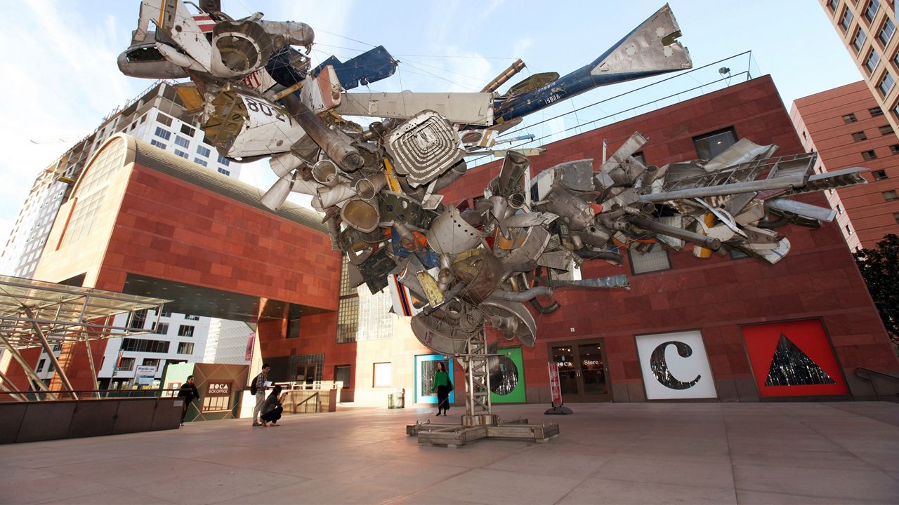 This Jan. 6, 2014, file photo shows "Airplane Parts," a sculpture by Nancy Rubins made of scraps of old airplanes wired together into a massive junk tree, greeting visitors to the Museum of Contemporary Art, MOCA, in downtown Los Angeles. The Museum of Contemporary Art in downtown Los Angeles says admission will soon be free thanks to a $10 million gift by the president of its board of trustees. Carolyn Powers announced her donation during an annual benefit dinner. (AP Photo/Nick Ut, File)