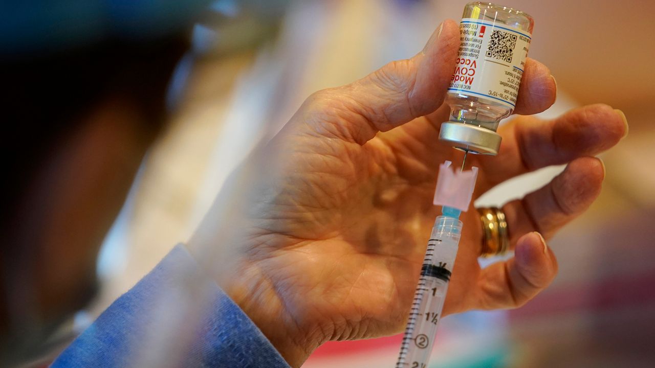 A health care worker fills a syringe with the Moderna COVID-19 vaccine (AP Photo, File)