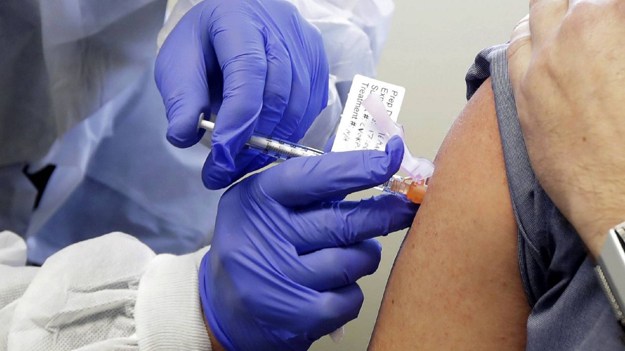 FILE - In this March file photo, receives a shot in the first-stage study of Moderna's potential vaccine for COVID-19. (AP Photo/Ted S. Warren, File)
