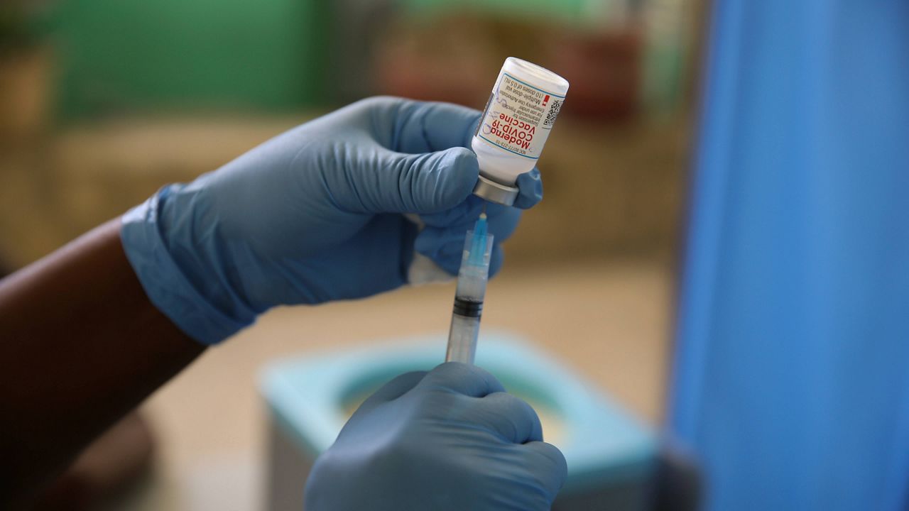 A health care worker prepares a syringe with Moderna's COVID-19 vaccine. (AP Photo, File)