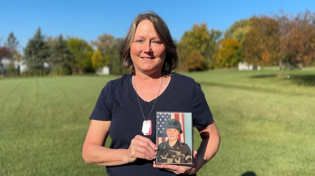 Mona Mcguire holds a picture of when she first enlisted in the U.S. Army.