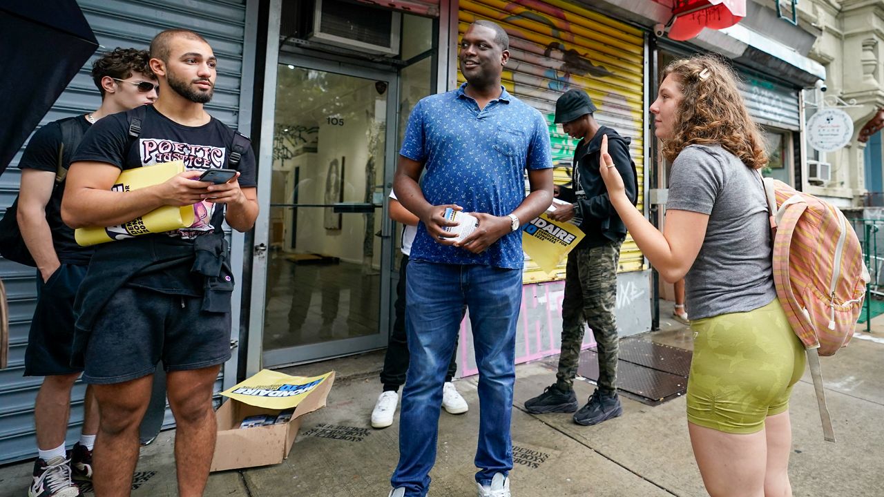 U.S. Rep. Mondaire Jones, D-N.Y., center, talks to campaign volunteers and staff during a canvass kick-off on the Lower East Side of Manhattan, Monday, Aug. 22, 2022. (AP Photo/Mary Altaffer)