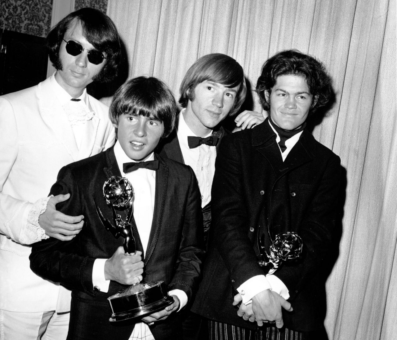 The Monkees pose with their Emmy award at the 19th Annual Primetime Emmy Awards in Calif. on June 4, 1967. They won for best comedy series and best comedy direction for their television program "The Monkees." The group members are, from left to right, Mike Nesmith, Davy Jones, Peter Tork, and Micky Dolenz. (AP Photo)