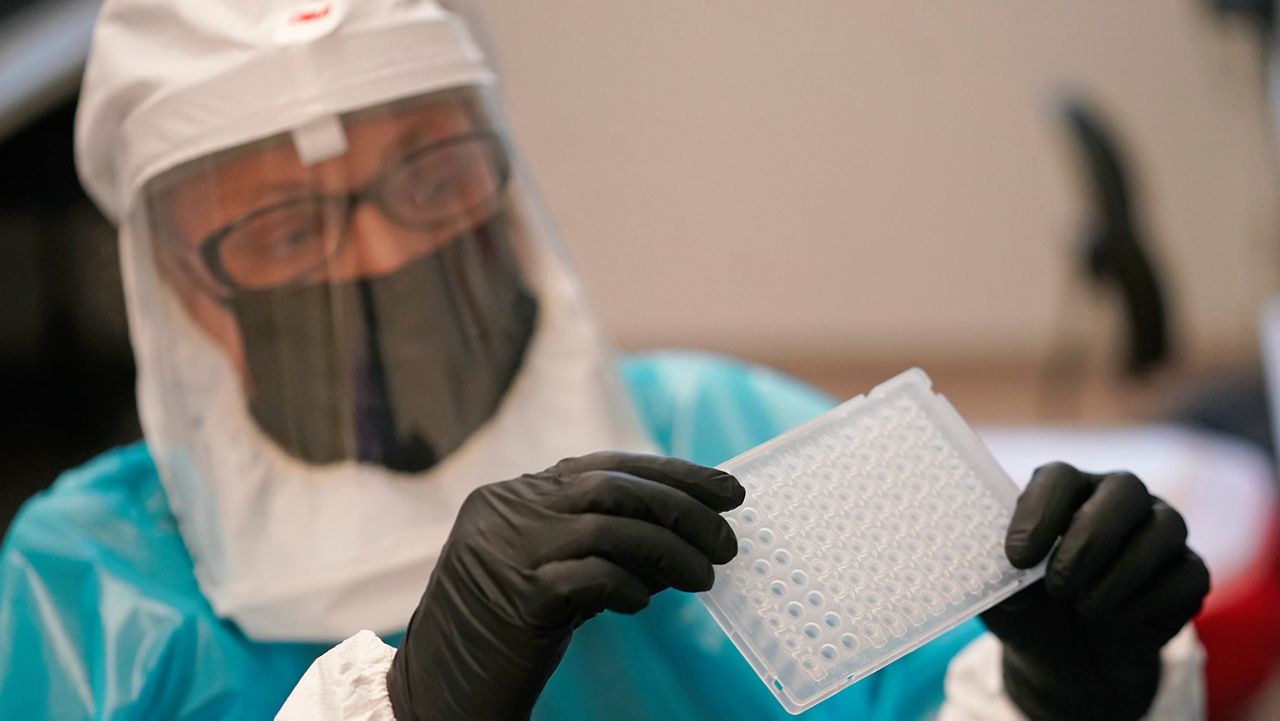 Microbiologist Annette Atkinson demonstrates how monkeypox is tested for Friday, July 29, 2022, in Taylorsville, Utah. (AP Photo/Rick Bowmer)