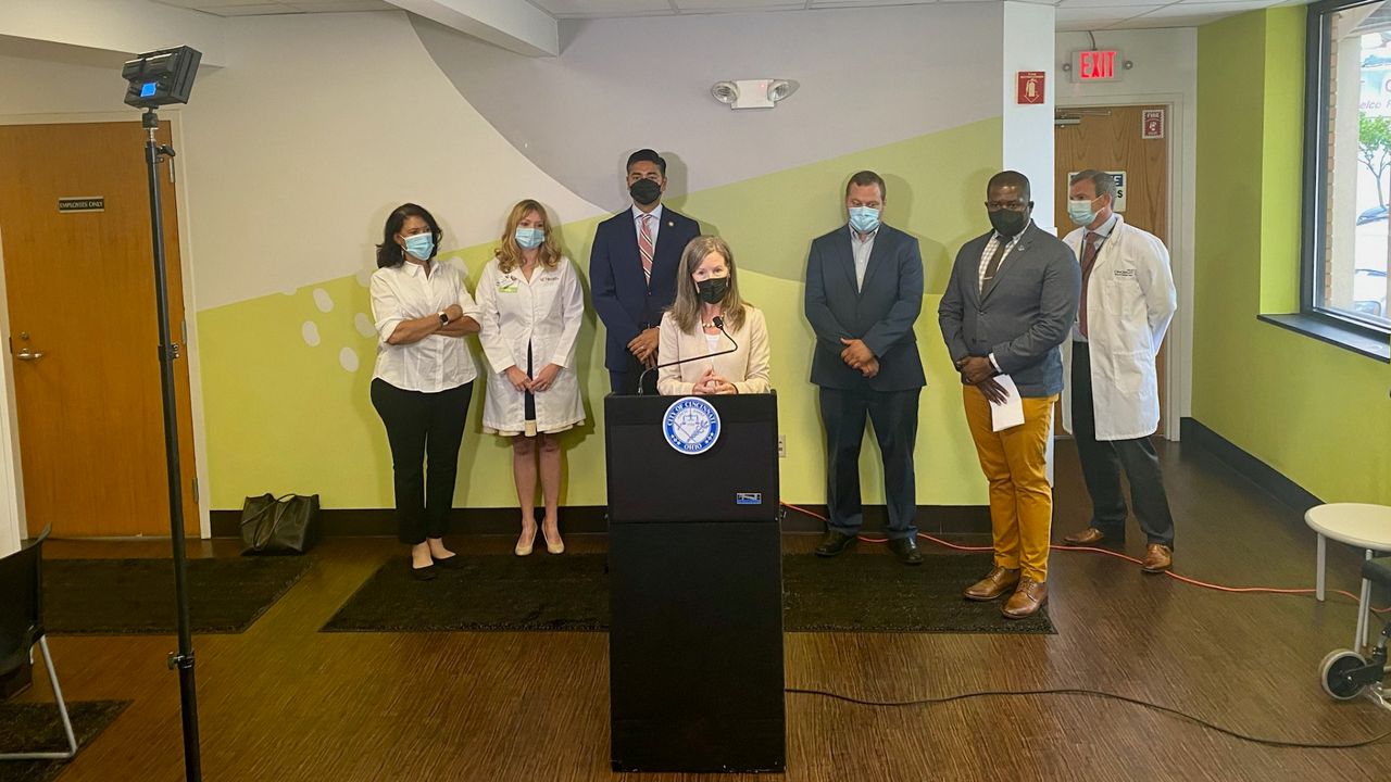 Cincinnati and Hamilton leaders gather to announce a joint effort to proactively address monkeypox in greater Cincinnati. The effort was led by City Council member Reggie Harris (right, gray suit jacket) (Casey Weldon/Spectrum News 1)