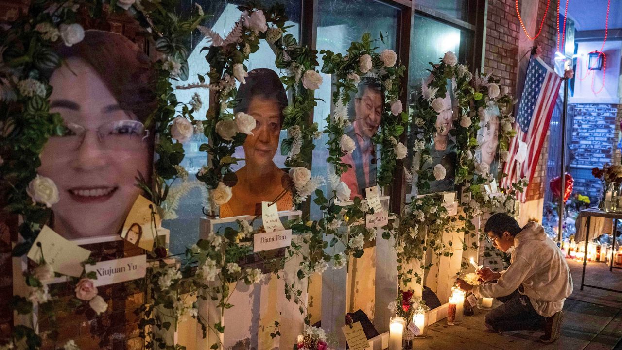 Eric Sham visits a makeshift memorial on Tuesday, Jan. 24, 2023 for those killed in a mass shooting at The Star Ballroom Dance Studio in Monterey Park. (Sarah Reingewirtz/The Orange County Register via AP)