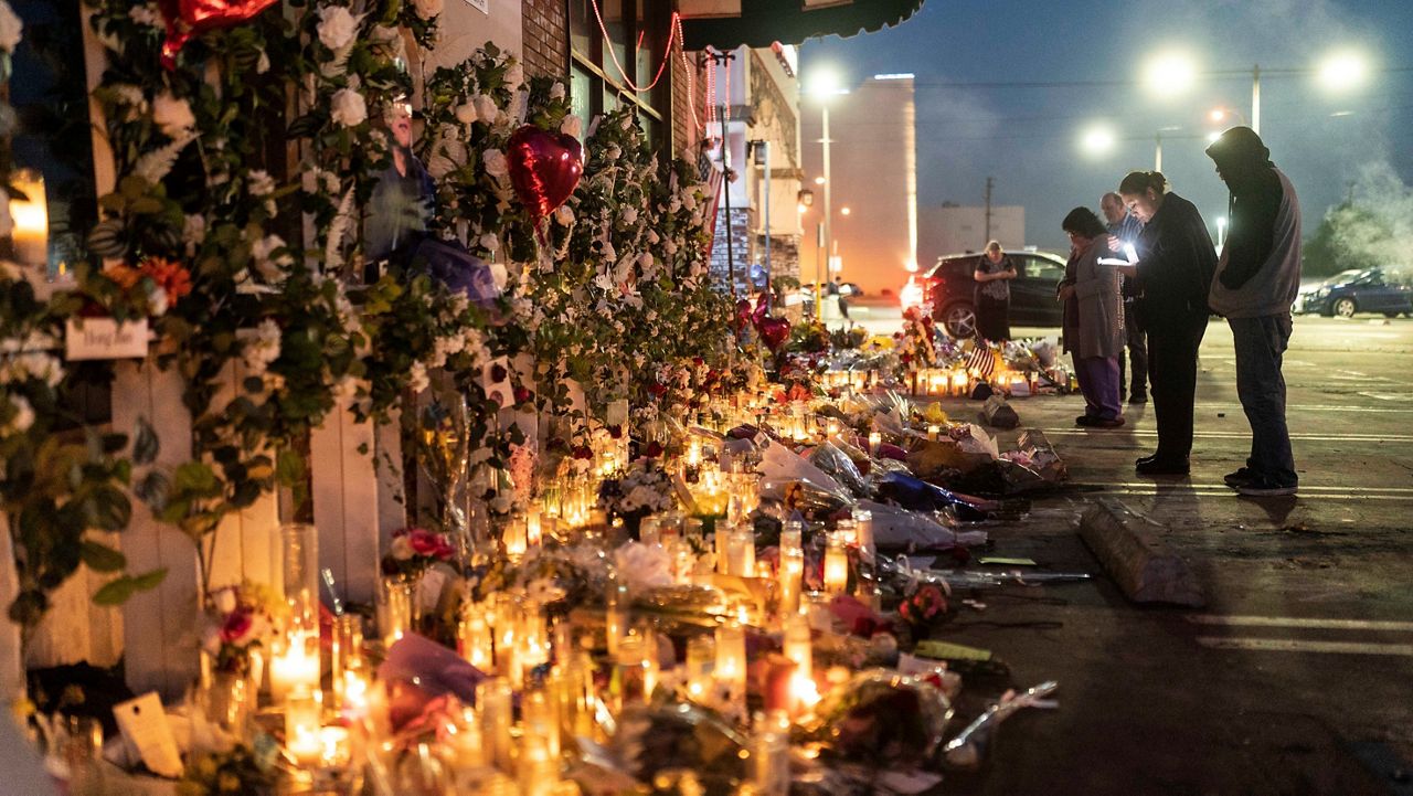 People pay their respects at a memorial outside Star Dance Studio in Monterey Park, Calif., Thursday, Jan. 26, 2023. (AP Photo/Jae C. Hong)