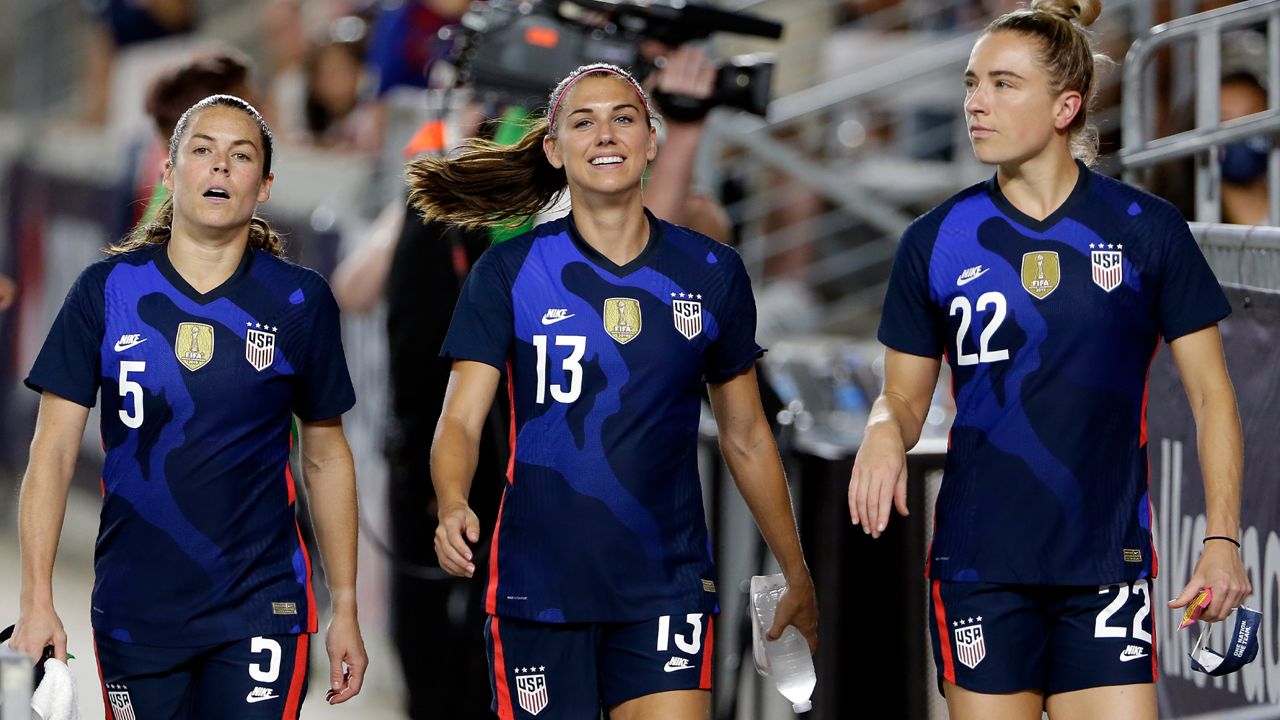 USA defender Kelley O'Hara (5), forward Alex Morgan (13) and midfielder Kristie Mewis (22) enter the field before their match against Jamaica in the 2021 WNT Summer Series match Sunday, June 13, 2021, in Houston. (AP Photo/Michael Wyke)