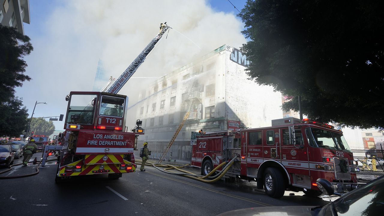 Fire crews battle a building fire on the 1200 block of South Hope Street Thursday, Dec. 26, 2024, in Los Angeles. (AP Photo/Damian Dovarganes)