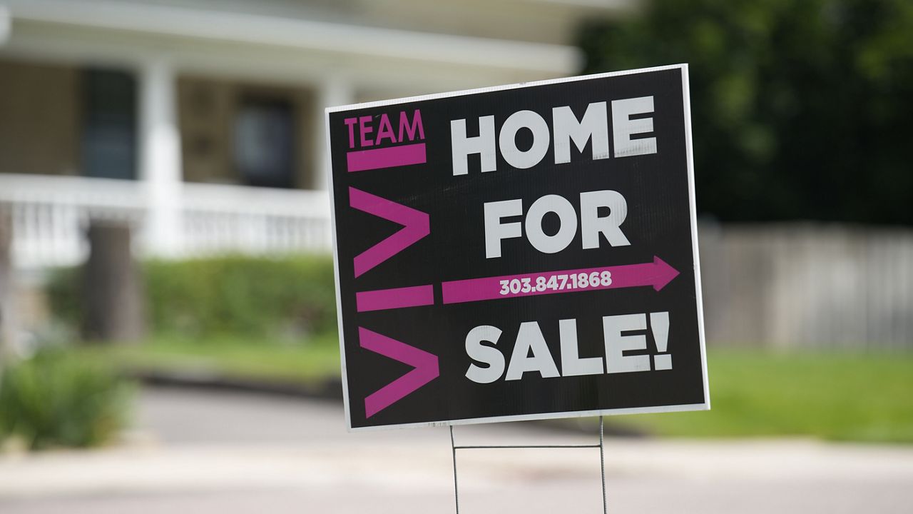 A for-sale sign stands outside a single-family residence on Sunday, June 18, 2023, in Denver. (AP Photo/David Zalubowski)