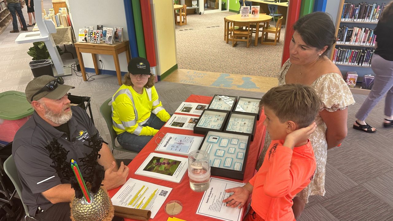 Volusia County Mosquito Control workers educate residents about reducing mosquito populations and preventing mosquito-borne diseases during a pop-up event this week. (Spectrum News)
