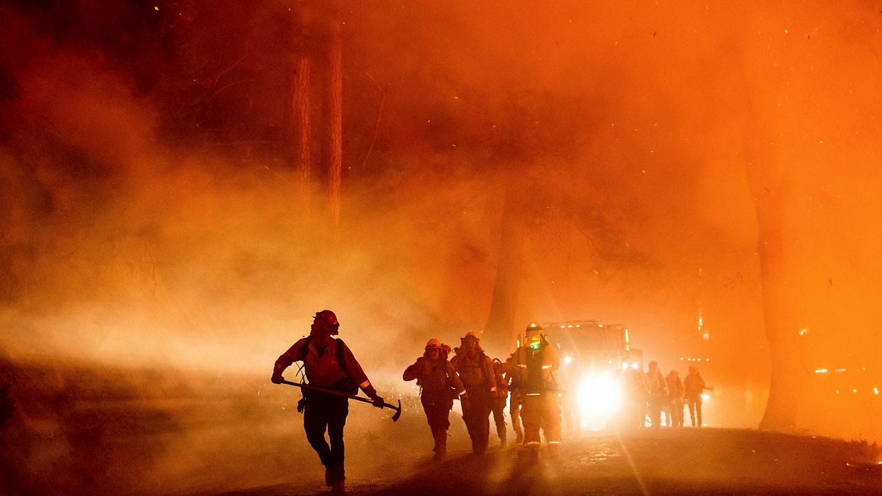 Firefighters battle the Mosquito Fire burning on Michigan Bluff Rd. in unincorporated Placer County, Calif., on Wednesday, Sept. 7, 2022. (AP Photo/Noah Berger, File)