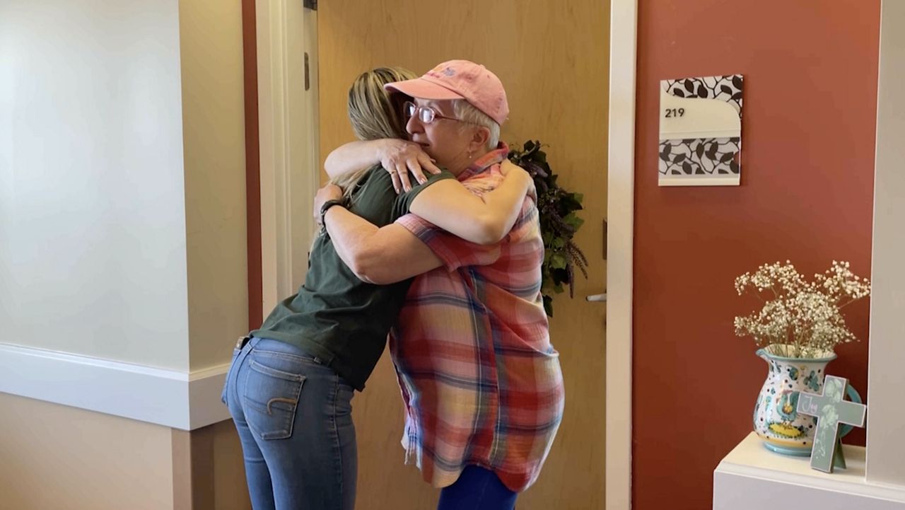 Two women hugging.