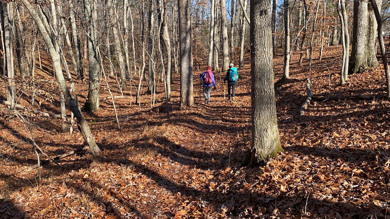 Two hikers get back to enjoy the scenery at the Corridor Trail a part of Pilot Mountain State Park