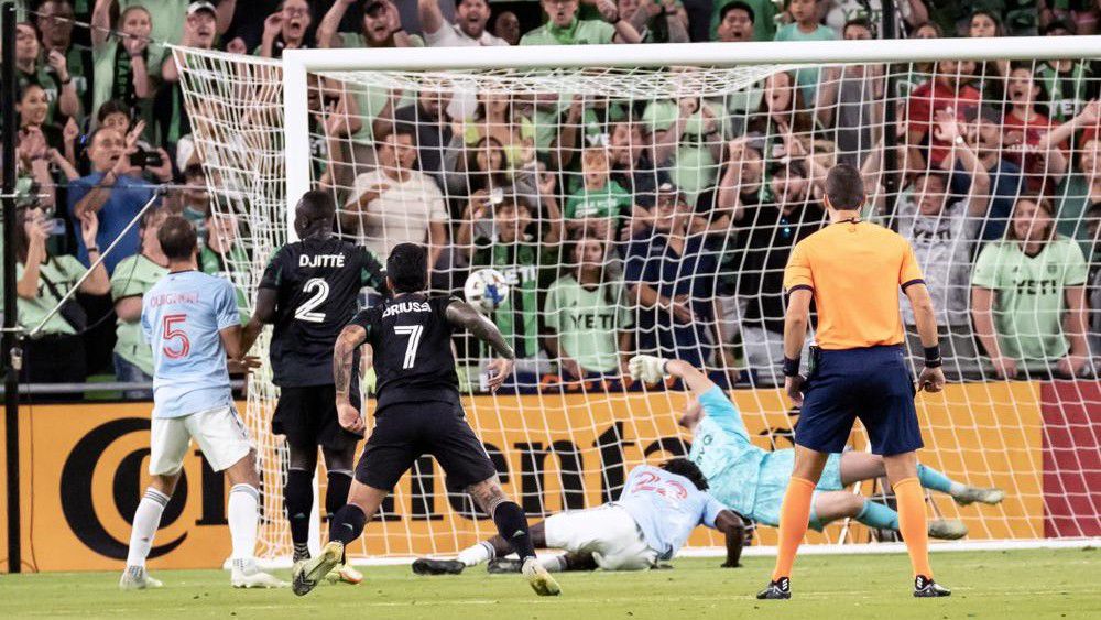Austin FC forward Moussa Djitte (2) scores a goal against FC Dallas goalkeeper Maarten Paes, second from right, during the first half an MLS playoff soccer match, Sunday, Oct. 23, 2022, in Austin, Texas. (AP Photo/Michael Thomas)