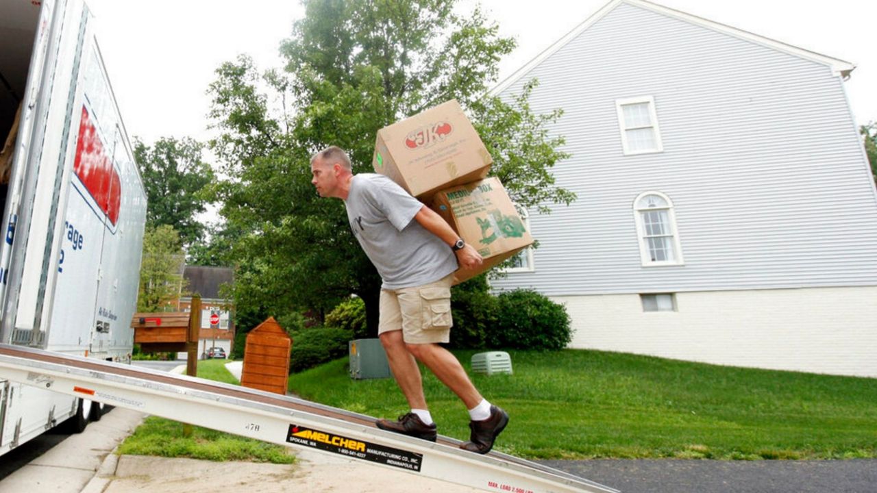 A person loading up the moving truck. (AP Images)