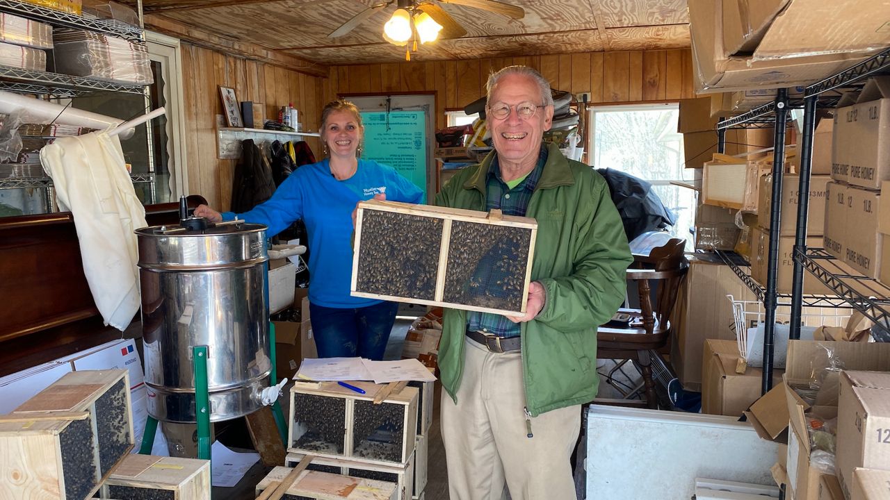 Emily Mueller of Mueller Honey Bee Co. and John Irvine are both members of the Summit County Beekeepers Assoc. (Jennifer Conn/Spectrum News1)