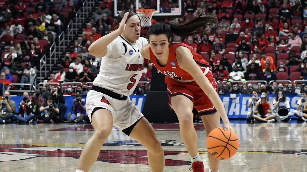 Gonzaga guard Abby O'Connor (4) tries to get around Louisville guard Mykasa Robinson (5) during the first half of a women's NCAA tournament college basketball second-ound game in Louisville, Ky., Sunday, March 20, 2022. (AP Photo/Timothy D. Easley)