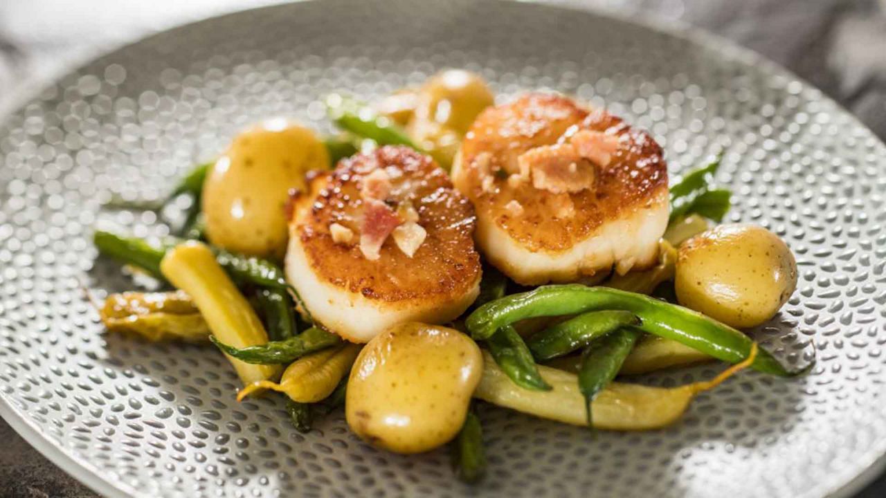 Seared scallops with French green beans, butter potatoes, brown vinaigrette and Applewood smoked bacon. (Courtesy of Disney Parks)
