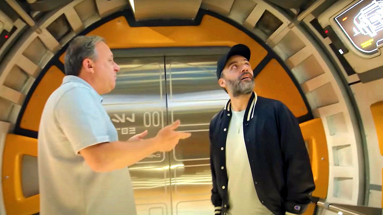 Walt Disney Imagineer Scott Trowbridge gives actor Oscar Isaac a tour of the Halcyon ship at Star Wars: Galactic Starcruiser. (Photo courtesy: Disney/YouTube)