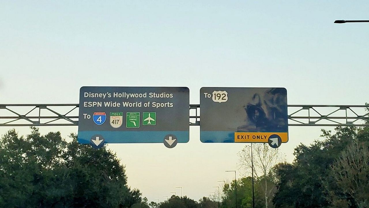 Road signs at Disney World featuring the new blue and yellow color scheme. They replace the purple and red signs. (Spectrum News/Ashley Carter)