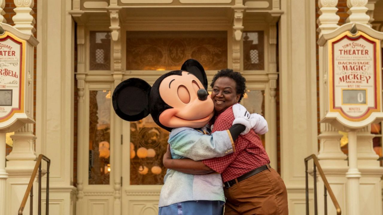 Mickey Mouse hugs Magic Kingdom cast member at Walt Disney World Resort celebration of the return of traditional character meet and greets. (Photo courtesy: Kent Phillips/Disney)