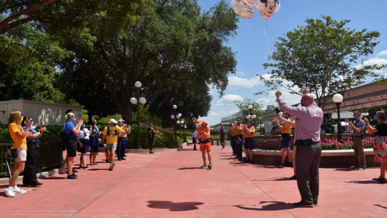 Don Muchow, 59, became the first person to run from Disneyland in California and Disney World in Florida when he crossed the finish line at Magic Kingdom on April 5. (Photo courtesy of Disney)