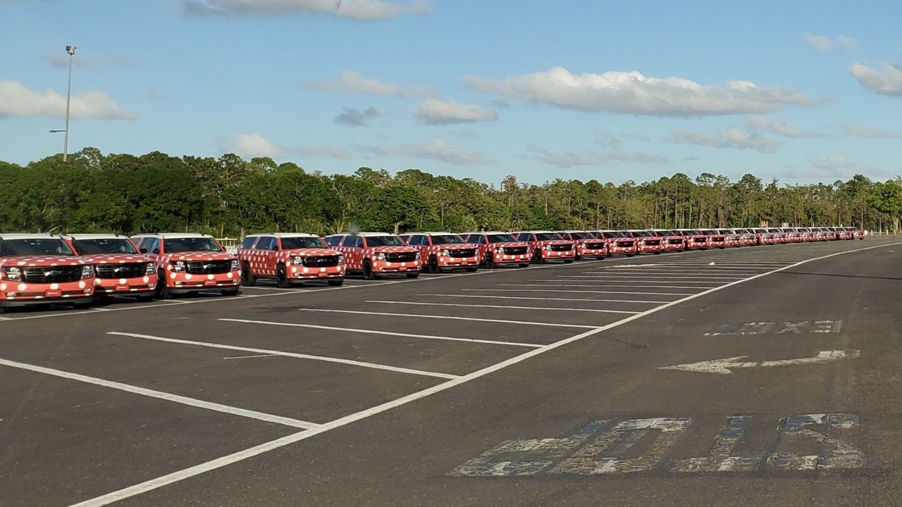 Minnie Vans parked in the lot at Epcot. The ride-share service will resume this summer. (Spectrum News/Ashley Carter)