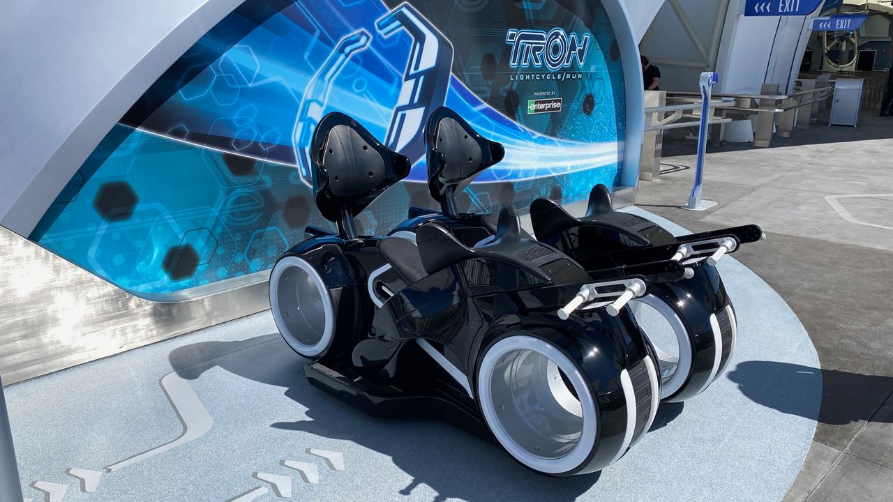 Lightcycle ride vehicles outside TRON Lightcycle Run at Magic Kingdom. (Spectrum News/Ashley Carter)