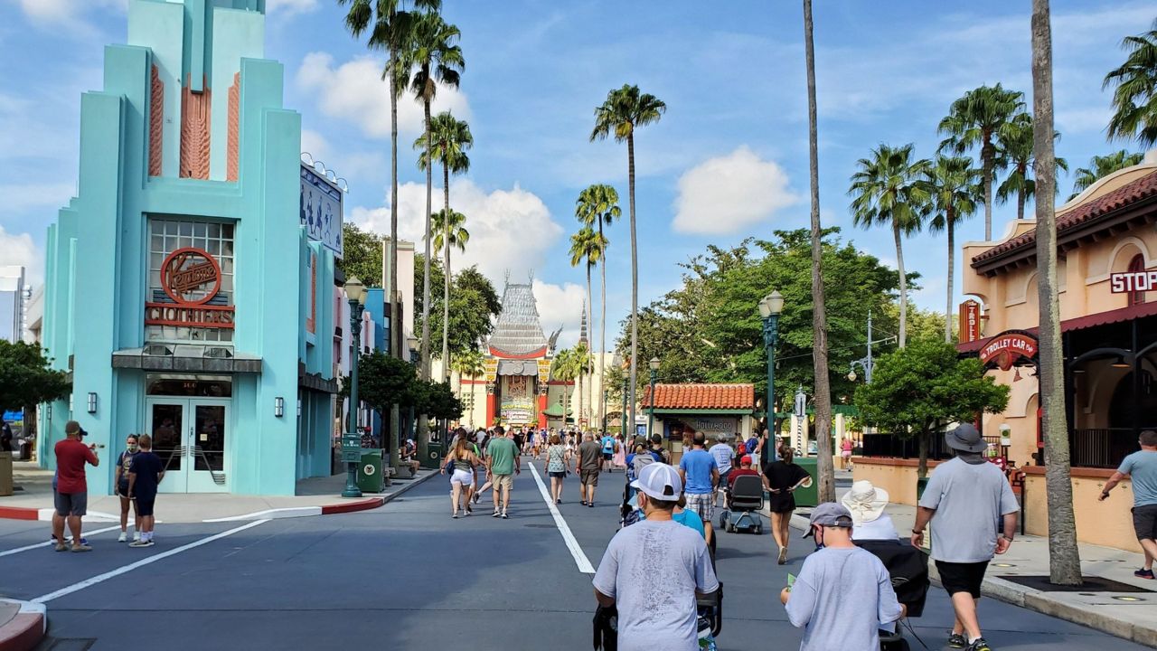 Visitors, while wearing masks, walk through Disney's Hollywood Studios on the first day of reopening, July 15, 2020. (Ashley Carter/Spectrum News)