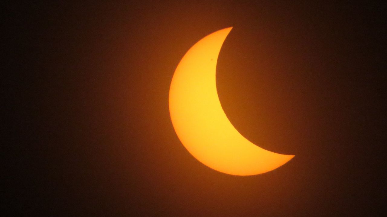 Many skywatchers grabbed solar glasses to watch the 2024 solar eclipse as the moon raced across the sun on Monday, April 08, 2024. (Spectrum News/Anthony Leone)