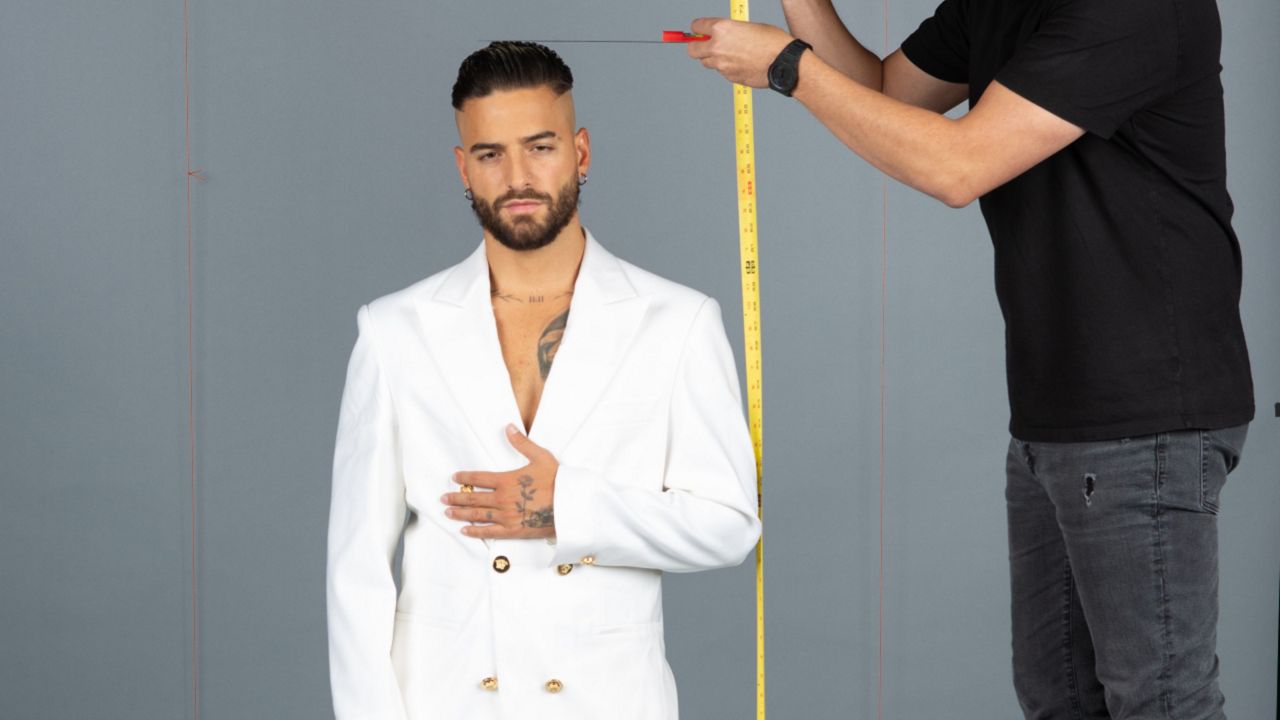 Colombian music artist Maluma poses as measurements are taken for his Madame Tussauds wax figure. (Merlin Entertainments)