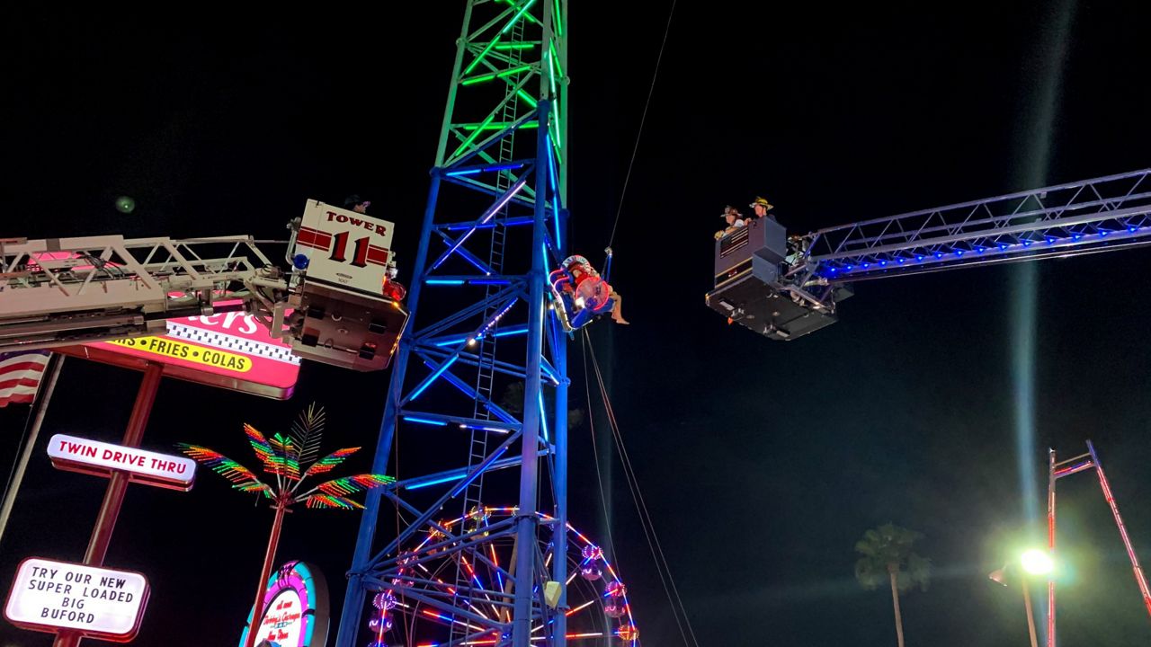 Two teens were rescued from the Slingshot ride in front of Old Town on Thursday after the ride malfunctioned. (Photo courtesy of Osceola County Fire Rescue)