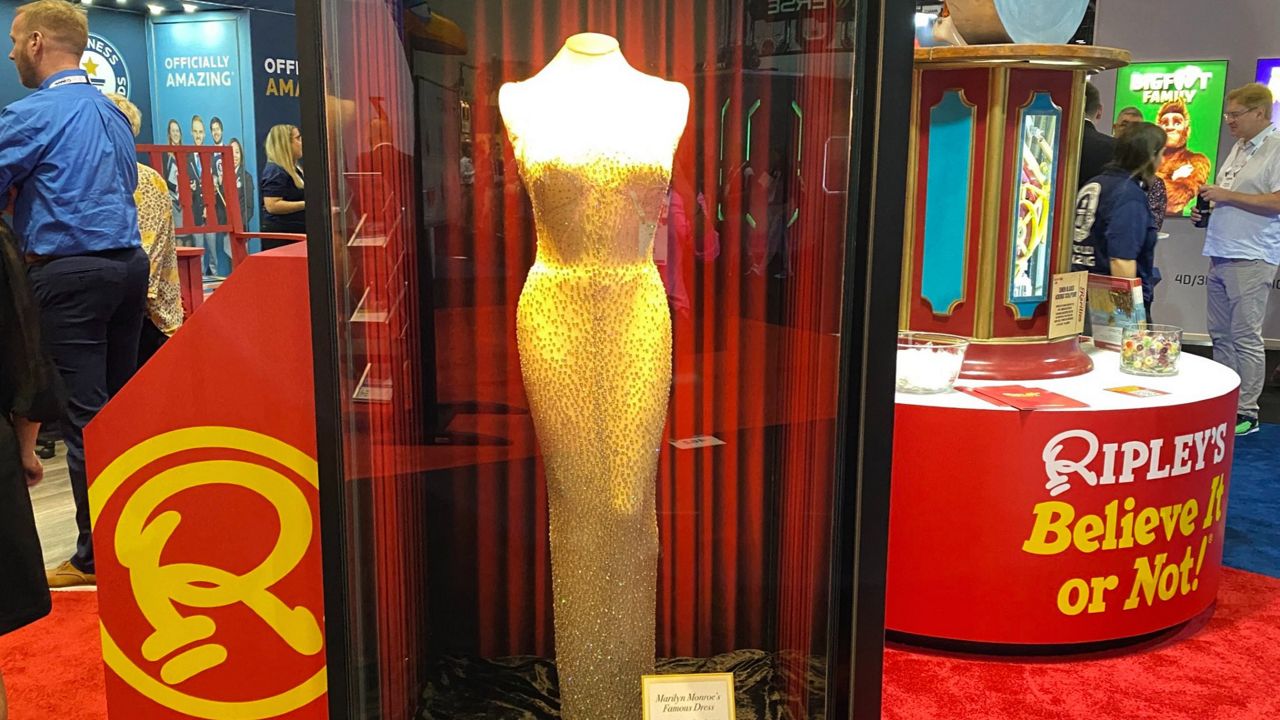 The dress Marilyn Monroe wore to President John F. Kennedy's 1962 birthday bash on display at the IAAPA Expo in Orlando. (Spectrum News/Ashley Carter)