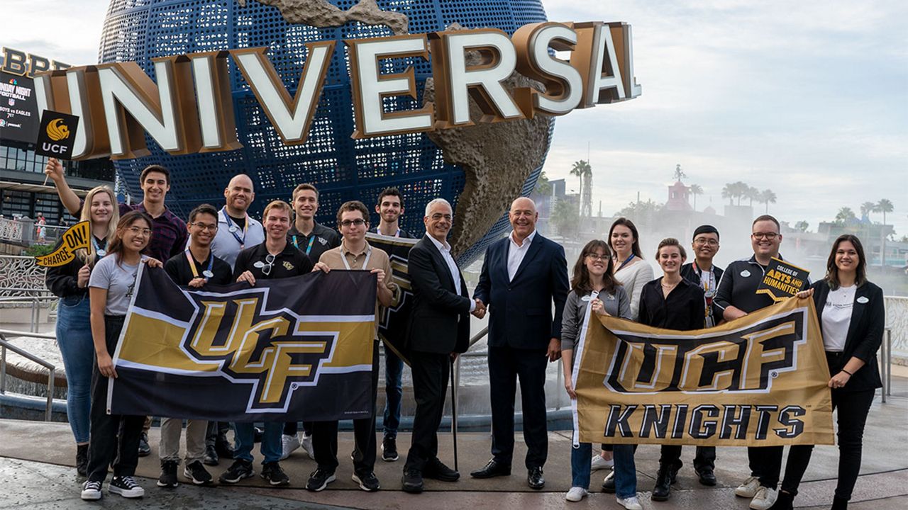 UCF students interning with Universal pose with UCF Themed Experience Program Director Peter Weishar (center, left) and Universal Creative President Mike Hightower (center, right). (Photo: Universal Orlando)